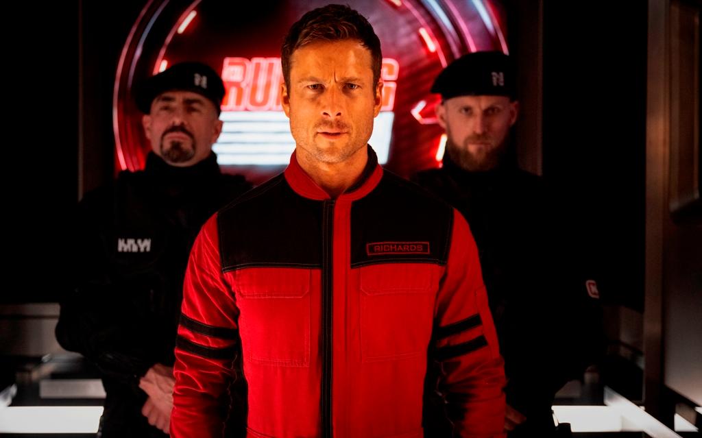 Glen Powell (C) as Ben Wilson in "The Running Man." (Paramount Pictures)