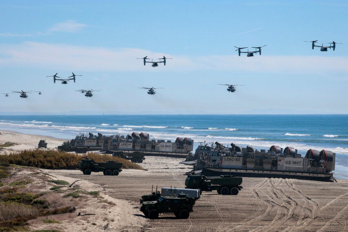 U.S. Navy Landing Craft Air Cushion's (LCAC) unload equipment onto the beach as U.S. Marine Corps V-22 Ospreys and CH-53 Super Stallions fly overhead during the America's Marines 250 event at Camp Pendleton's Red Beach in Oceanside, Calif., on Oct. 18, 2025. (Mario Tama/Getty Images)