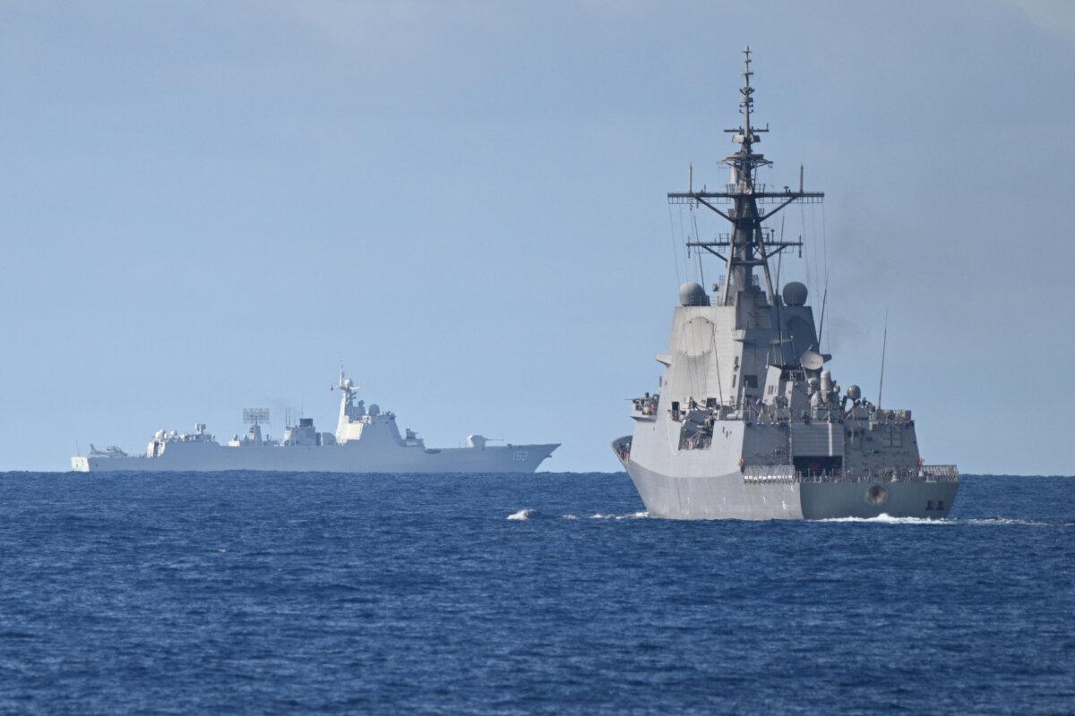 What Trump’s National Security Strategy Means for Canada | USNN World News A Chinese PLA Navy ship (background L) is seen while the an Australian Navy destroyer (R) takes part in a maritime cooperative activity near Scarborough Shoal, on Sept/ 3, 2025. (Ted Aljibe/AFP via Getty Images)