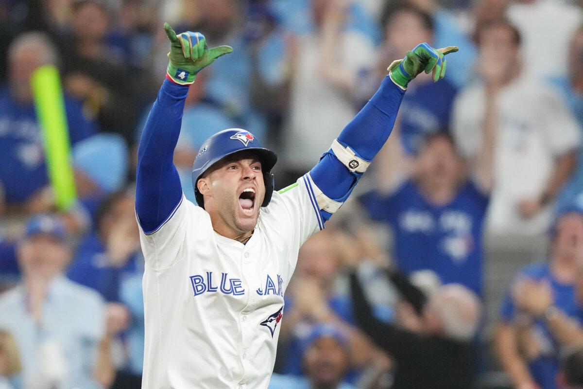 Toronto Blue Jays' George Springer celebrates after hitting a three-run home run against the Seattle Mariners during the seventh inning in Game 7 of baseball's American League Championship Series in Toronto, on Oct. 20, 2025. (Nathan Denette/The Canadian Press via AP)