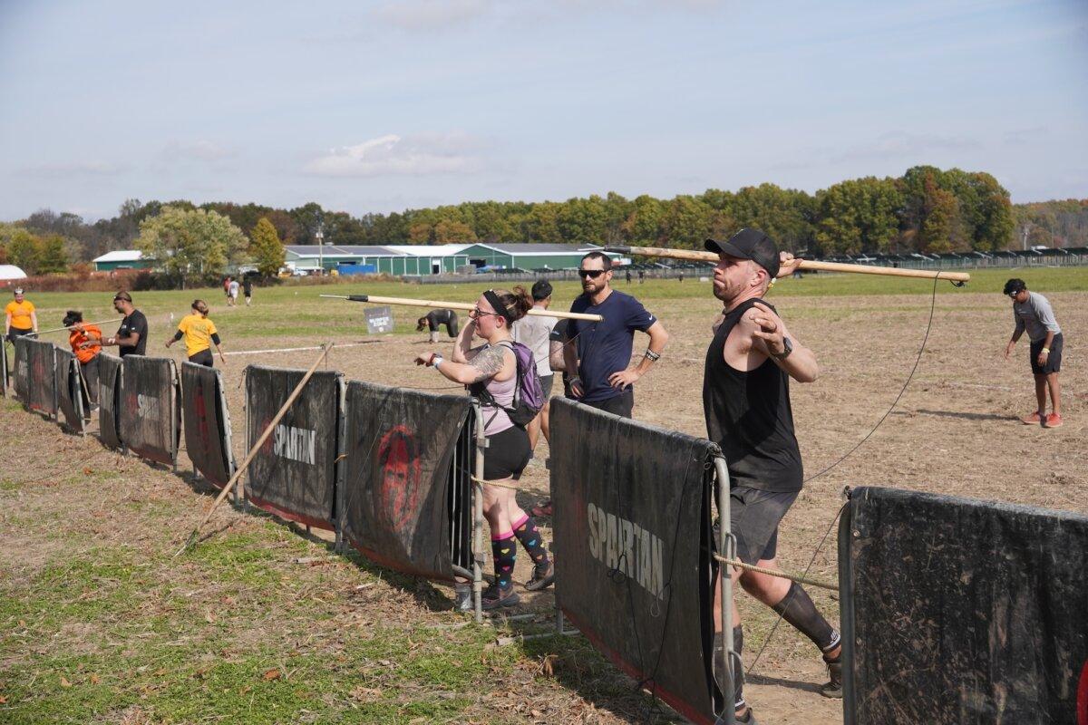 Runners throw javelins at the 2025 Tri-State New York Spartan Event Weekend in the Town of New Hampton, N.Y., on Oct. 19, 2025. (Oliver Mantyk/The Epoch Times)