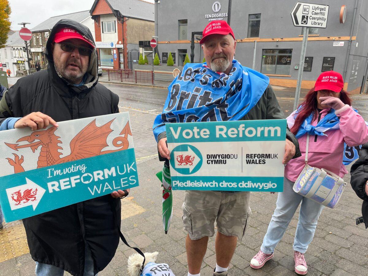 Reform supporter Peter May (C) with his wife (R) and friend (L), in Caerphilly, Wales, on Oct. 24, 2025 (Owen Evans/Epoch Times)