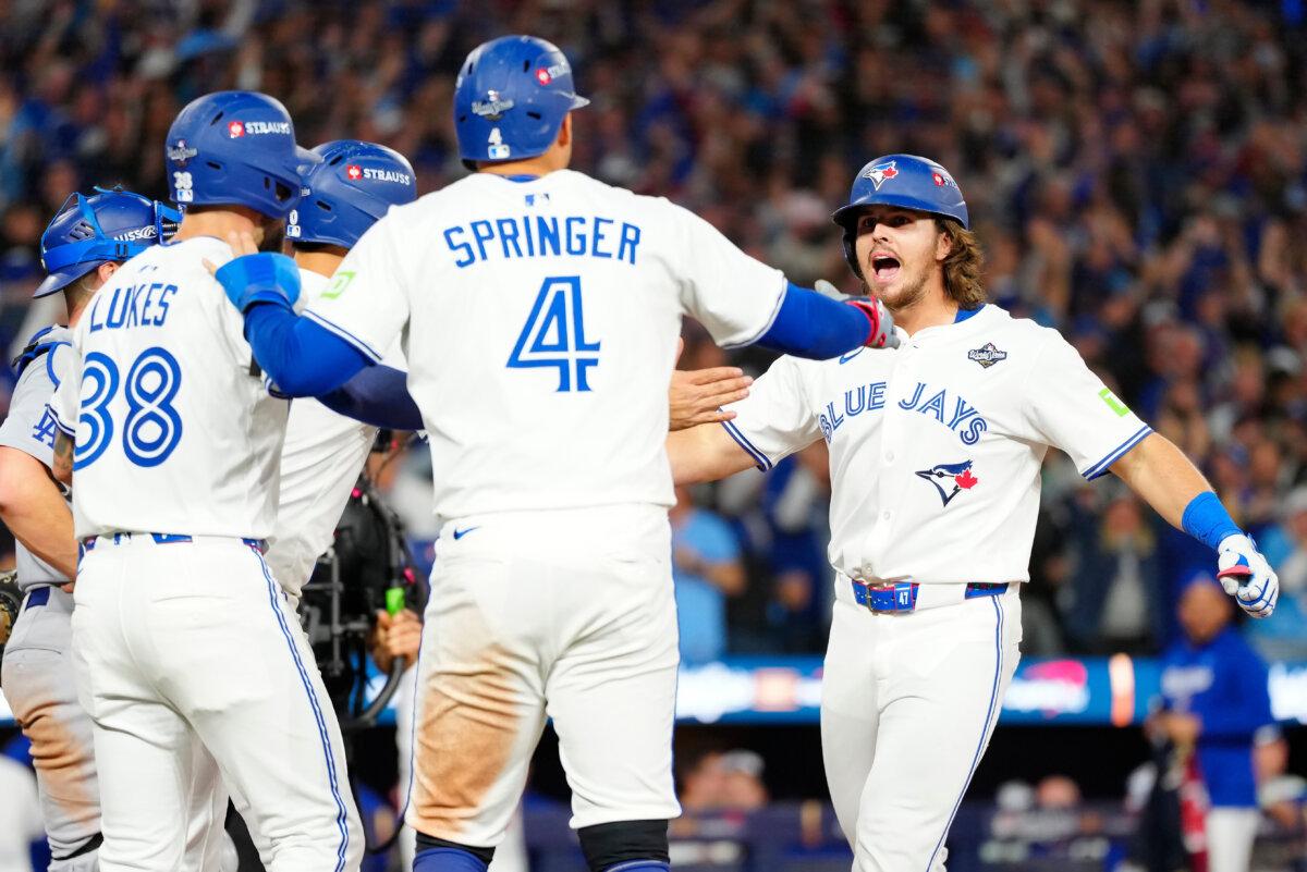 Blue Jays' Addison Barger (R) celebrates with teammates after hitting a grand slam against the Los Angeles Dodgers during the sixth inning of Game 1 of MLB's World Series in Toronto on Oct. 24, 2025. (Frank Gunn/The Canadian Press via AP)