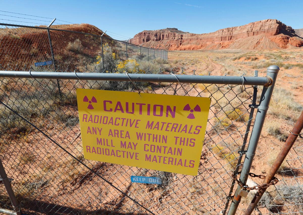 A radioactive warning sign hangs on fencing around Anfield Energy's Shootaring Canyon uranium mill outside Ticaboo, Utah, on Oct. 27, 2017. (George Frey/Getty Images)