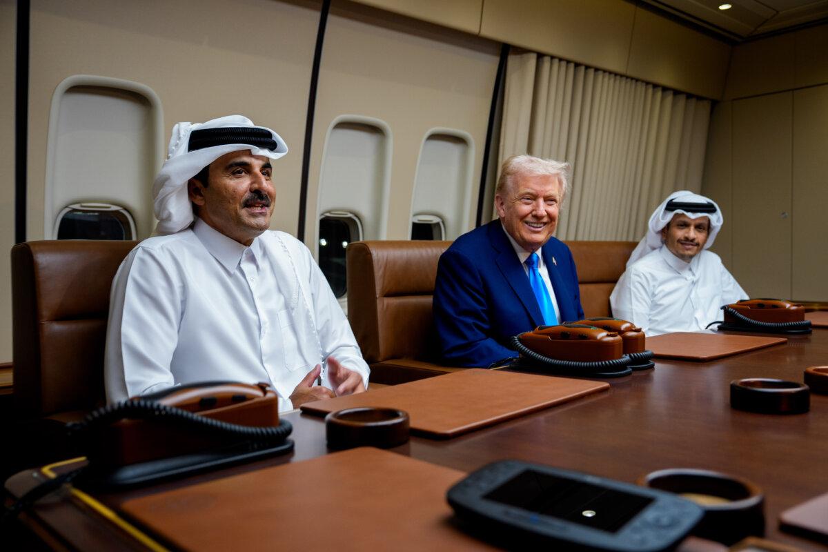 Emir of Qatar Sheikh Tamim ibn Hamad Al Thani (L), accompanied by Prime Minister of Qatar Mohammed bin Abdulrahman bin Jassim bin Jaber Al Thani (R), speaks as U.S. President Donald Trump welcomes them aboard Air Force One during a refueling stop at Al-Udeid Air Base in Abu Nakhlah, Qatar, on Oct. 25, 2025. (Andrew Harnik/Getty Images)