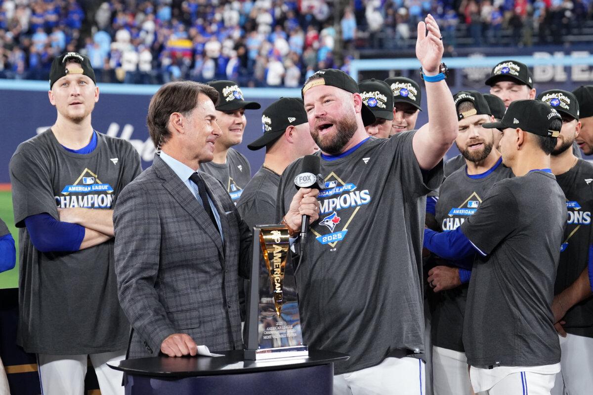 Manager John Schneider #14 of the Toronto Blue Jays is interviewed after winning game seven of the American League Championship Series against the Seattle Mariners at the Rogers Centre in Toronto, Ontario on Oct. 20, 2025. (Mark Blinch/Getty Images)