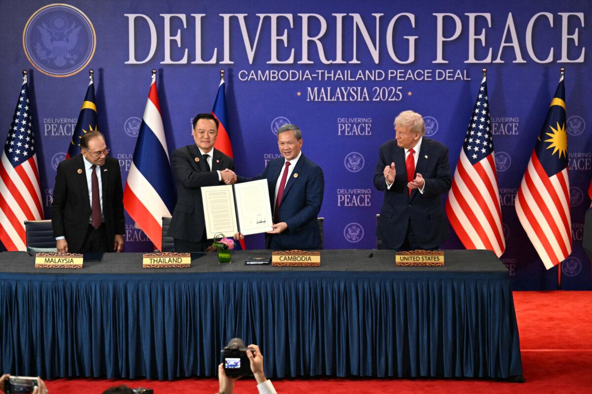 Malaysian Prime Minister Anwar Ibrahim (L) and U.S. President Donald Trump (R) watch as Thai Prime Minister Anutin Charnvirakul, (2nd L) and Cambodian Prime Minister Hun Manet (2nd R) hold up a document after the ceremonial signing of a cease-fire agreement between Thailand and Cambodia on the sidelines of the 47th Association of Southeast Asian Nations summit in Kuala Lumpur, Malaysia, on Oct. 26, 2025. (Mohd Rasfan/AP)