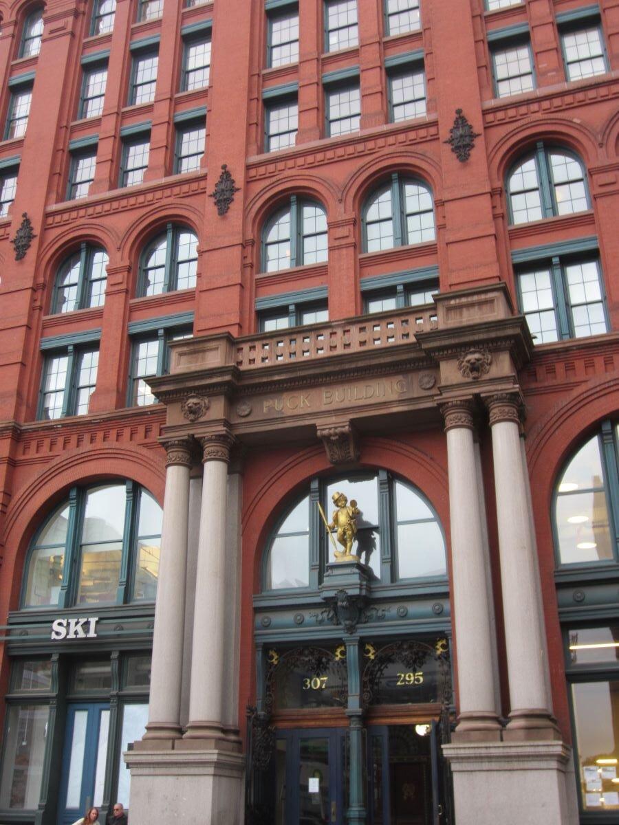 The Lafayette Street entrance of the Puck Building in Manhattan with a gilded statue of Puck over its entrance. (<a href="https://commons.wikimedia.org/wiki/User:Another_Believer">Another Believer</a>/<a href="https://creativecommons.org/licenses/by-sa/3.0/">CC BY-SA 3.0</a>)