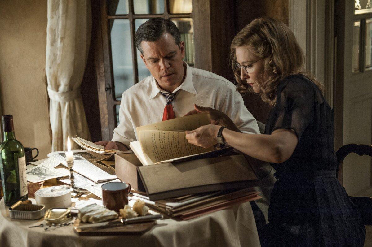 Lt. James Granger (Matt Damon) and Claire Simone (Cate Blanchett) research documents to save works of art, in “The Monuments Men.” (Columbia Pictures/MovieStillsDB)