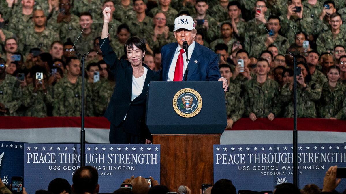 Japanese Prime Minister Sanae Takaichi waves as U.S. President Donald Trump speaks aboard USS George Washington in Yokosuka, Japan, on Oct. 28, 2025. (Tomohiro Ohsumi/Getty Images)