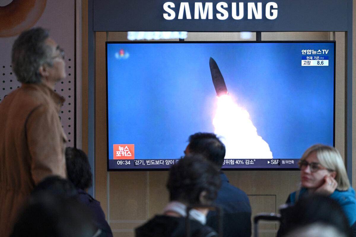 People sit in front of a television screen showing a news broadcast with file footage of a North Korean missile test, at a train station in Seoul, South Korea, on Oct. 22, 2025. (Jung Yeon-je/AFP)