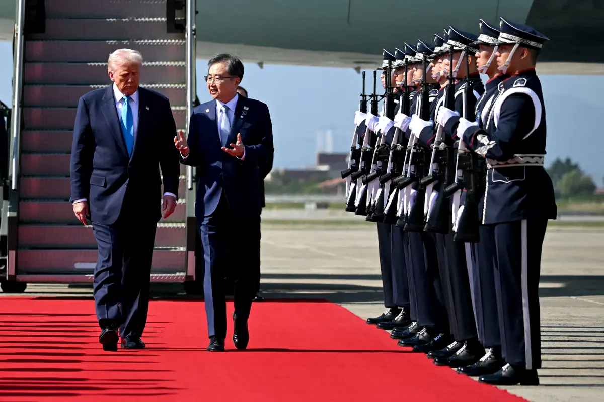 U.S. President Donald Trump is greeted by South Korean Foreign Minister Cho Hyun upon his arrival at the airport in Gyeongju, South Korea, on Oct. 29, 2025. (Andrew Caballero-Reynolds/AFP via Getty Images)