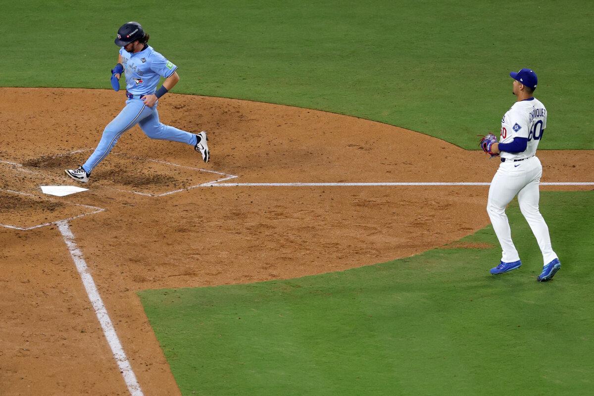 Addison Barger of the Toronto Blue Jays advances home to score a run on a wild pitch by Edgardo Henriquez of the Los Angeles Dodgers during the seventh inning in Game 5 of the 2025 World Series at Dodger Stadium in Los Angeles on Oct. 29, 2025. (Sean M. Haffey/Getty Images)