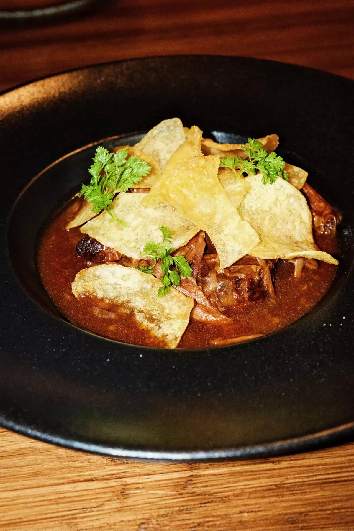 Rabo de toro, or slow-cooked oxtails with potato chips, at Casa Leo. (Stephanie Breijo/Los Angeles Times/TNS)