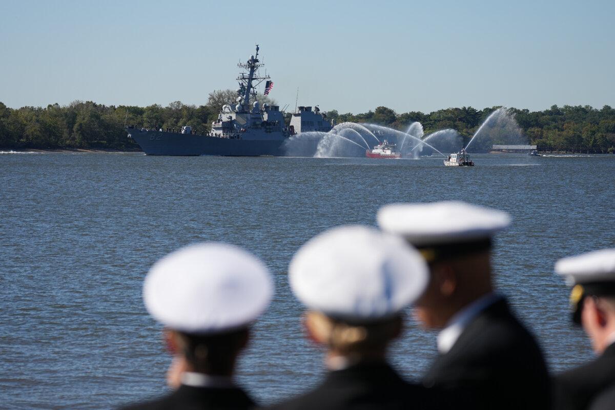 Spectators look on as U.S. Navy ships pass the viewing stand during the 250th anniversary of the founding of the U.S. Navy and Marine Corps, along the Delaware River in Philadelphia on Oct. 9, 2025. (Matt Rourke/AP Photo)