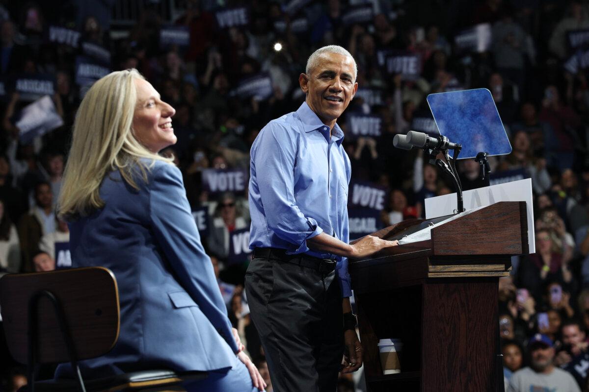 Former U.S. President Barack Obama speaks as Virginia Democratic gubernatorial candidate Abigail Spanberger (L), a former Congresswoman, sits next to him during a campaign rally in Norfolk, Va., on Nov. 1, 2025. (Win McNamee/Getty Images)