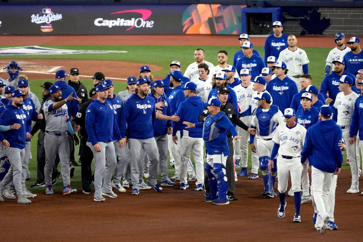 The Los Angeles Dodgers and the Toronto Blue Jays benches clear after Blue Jays' Andrés Giménez was hit by a pitch during the fourth inning in Game 7 of baseball's World Series in Toronto on Nov. 1, 2025. (Ashley Landis/AP Photo)