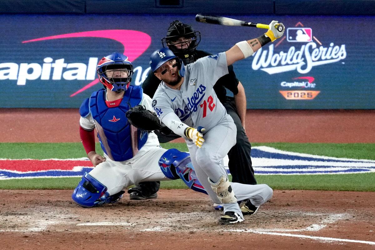 Los Angeles Dodgers' Miguel Rojas follows through on a home run against the Toronto Blue Jays during the ninth inning in Game 7 of baseball's World Series in Toronto on Nov. 1, 2025. (Ashley Landis/AP Photo)