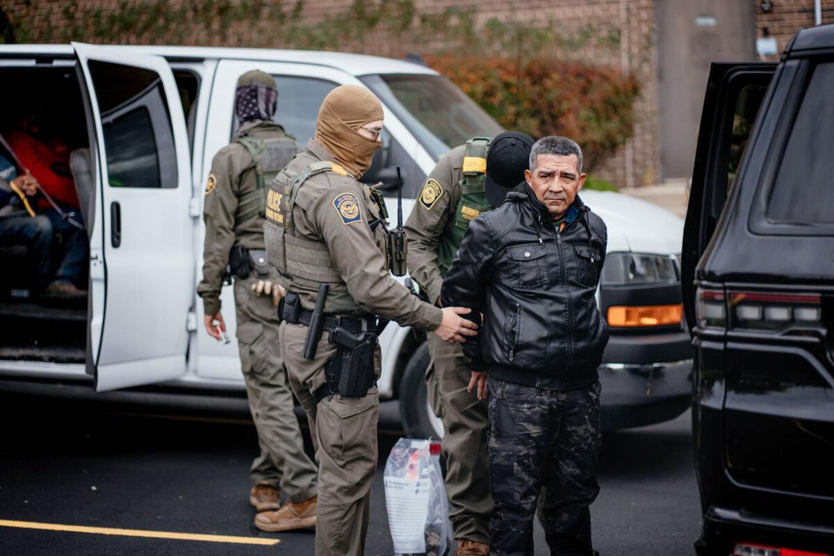 People detained earlier in the day are taken to a parking lot on the far north side of Chicago before being transferred to an Immigration and Customs Enforcement facility, on Oct. 31, 2025. (Jamie Kelter Davis/Getty Images)