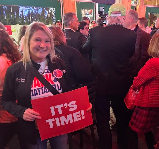 Alene Stewart holds a placard with New Jersey Republican governor candidate Jack Ciattarelli's campaign theme at Kelly's Tavern in Neptune City on Nov. 3, less than 12 hours before Election Day polls open. (Epoch Times/John Haughey)