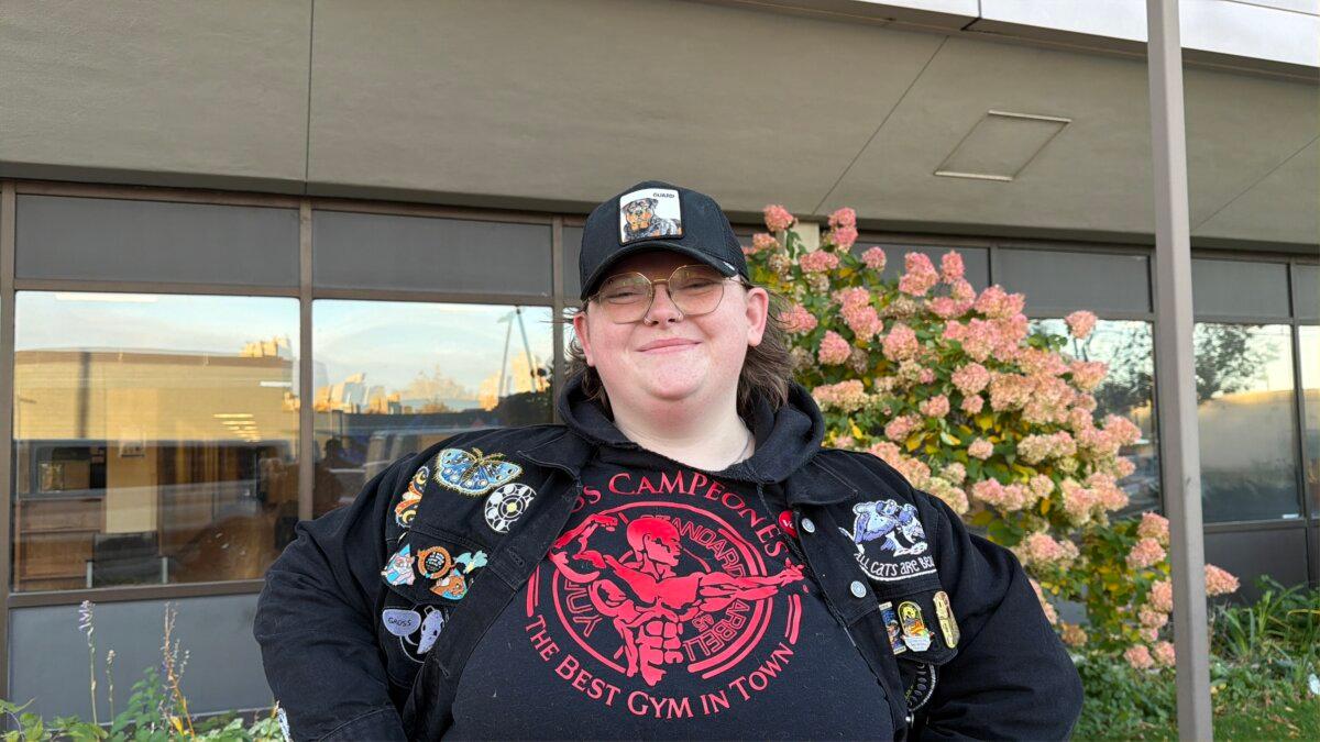 A woman who identified herself as Hannah poses for a photo outside the Heltzer Manor Highrise, a polling place in Ward 6, Precinct 8, in Minneapolis on Nov. 4, 2025. (Janice Hisle/The Epoch Times)
