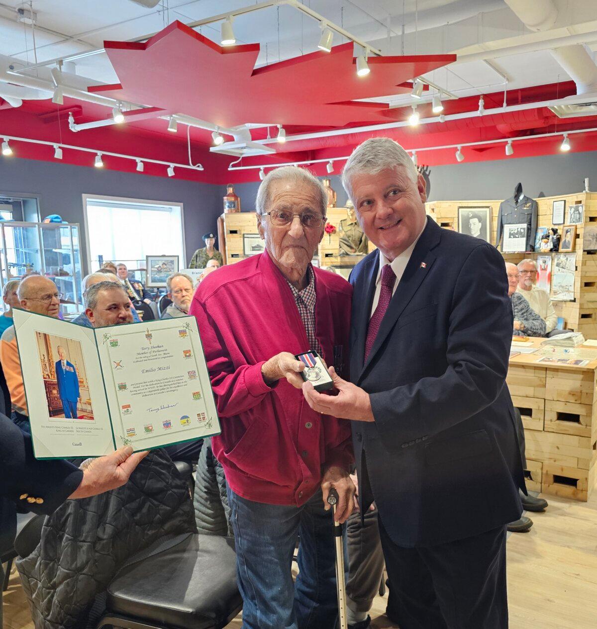 Mel Mizzi (L), pictured with Liberal MP Terry Sheehan, is awarded the King Charles III Coronation Medal at a ceremony held at Royal Canadian Legion Branch 25 in Sault Ste. Marie, Ont., on March 29, 2025. (Courtesy Christine Marasco)