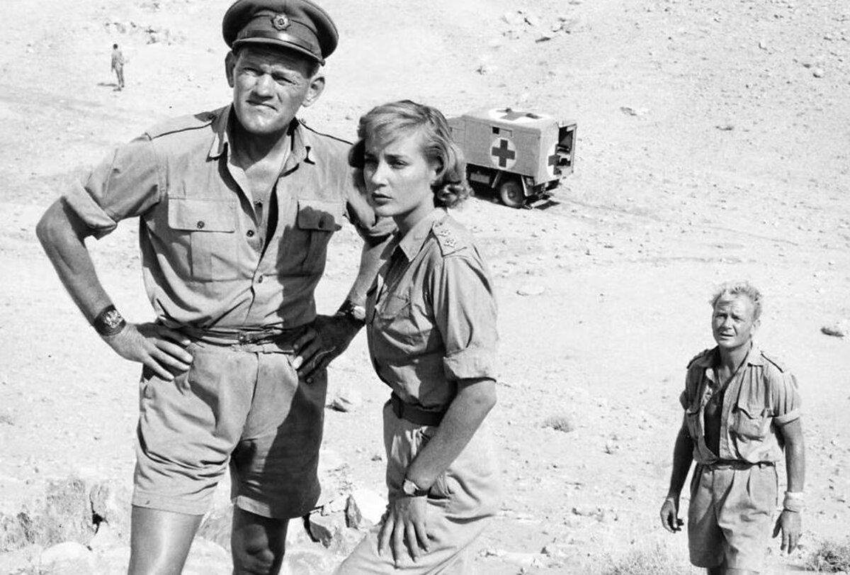 (L–R) Sgt. Maj. Tom Pugh (Harry Andrews), Sister Diana Murdoch (Sylvia Syms), and Capt. Anson (John Mills), in “Ice Cold in Alex.” (Associated British-Pathe/ 20th Century Fox)