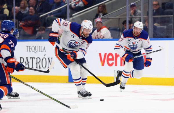 Leon Draisaitl (29) and Connor McDavid (97) of the Edmonton Oilers skate against the New York Islanders at UBS Arena in Elmont, N.Y., on Oct. 16, 2025. (Bruce Bennett/Getty Images)