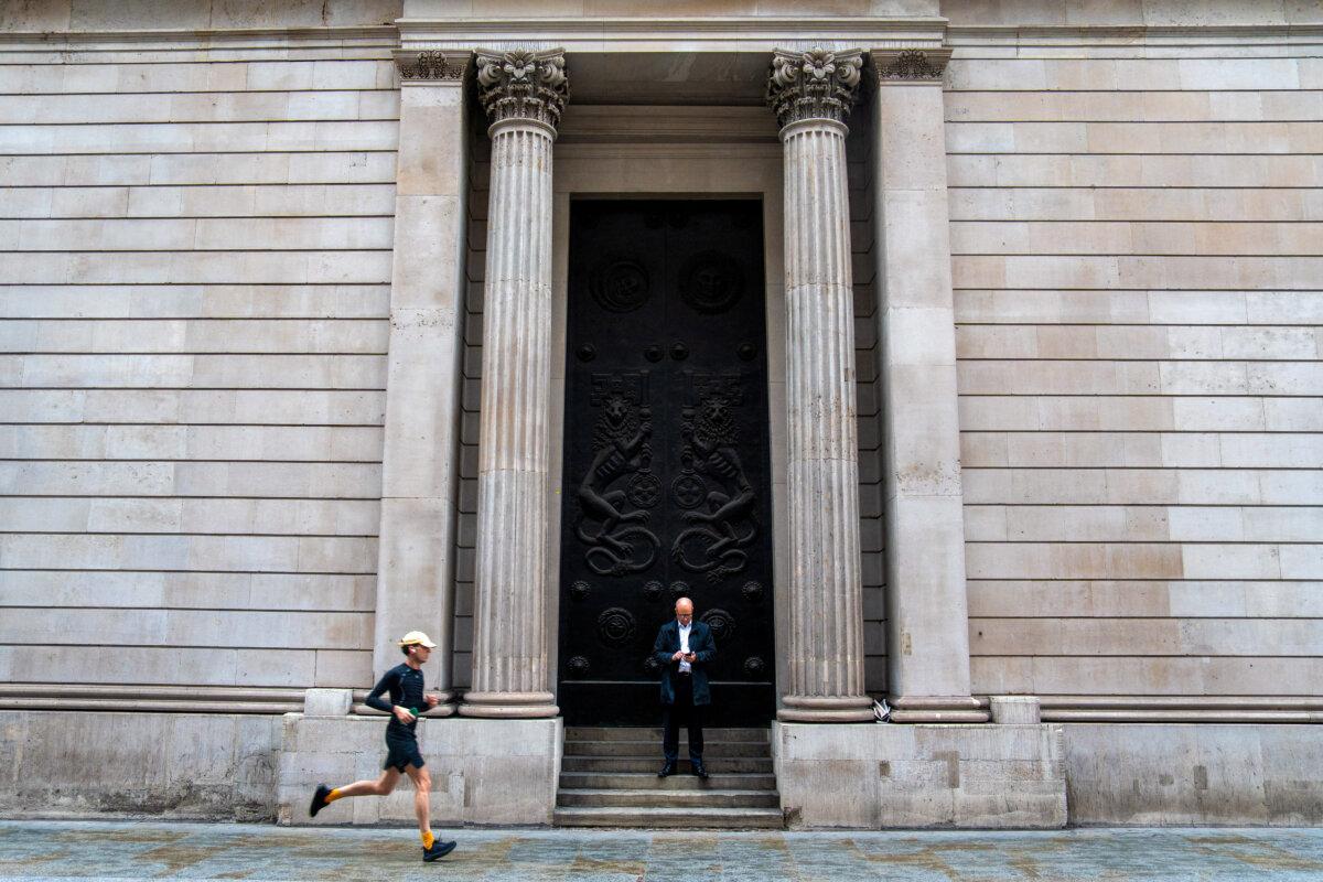 A man jogs past the exterior of the Bank of England in central London on November 6, 2025. (Niklas Halle'n/AFP via Getty Images)