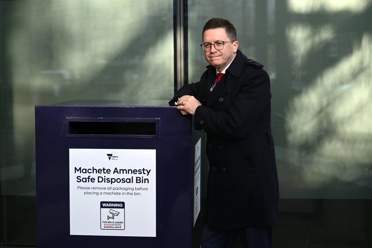 Victorian Minister for Police Anthony Carbines poses for a photo with a Machete Amnesty Safety Disposal Bin after announcement on the state's machete ban at Melbourne West Police Station in Melbourne in Victoria, Australia, July 31, 2025. (AAP Image/Joel Carrett)