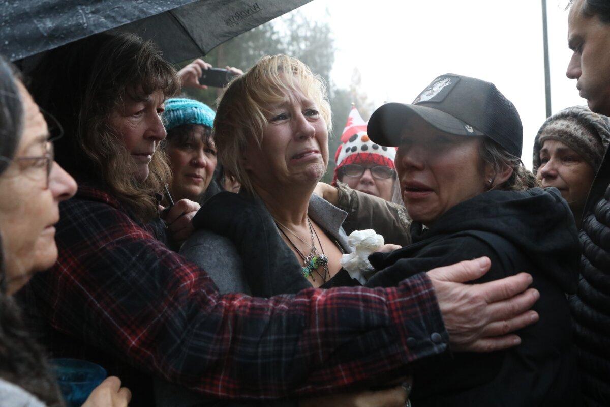 Karen Espersen, the co-owner of Universal Ostrich Farms, is embraced by supporters and her daughter, Katie Pasitney, at the farm in Edgewood, B.C., after the Supreme Court of Canada declined to hear the farm’s appeal against an order to cull more than 300 of its ostriches, on Nov. 6, 2025. (The Canadian Press/Aaron Hemens)