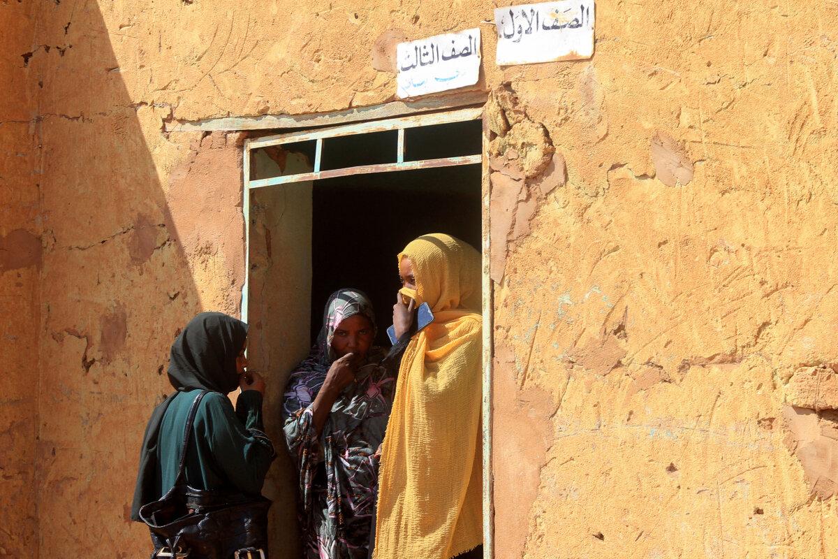 Three women, part of a group of displaced people from the towns of Bara and Umm Dam Haj Ahmed in North Kordofan State, take shelter in Omdurman, part of Greater Khartoum, on Nov. 10, 2025. (Ebrahim Hamid/AFP)