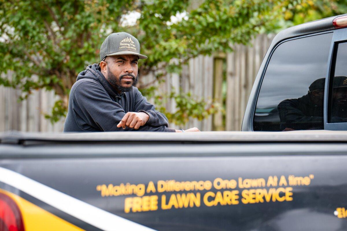 Rodney Smith Jr., founder of Raising Men and Women Lawn Care Service, in front of his truck in Madison, Ala., on Oct. 28, 2025.(Samira Bouaou/The Epoch Times)