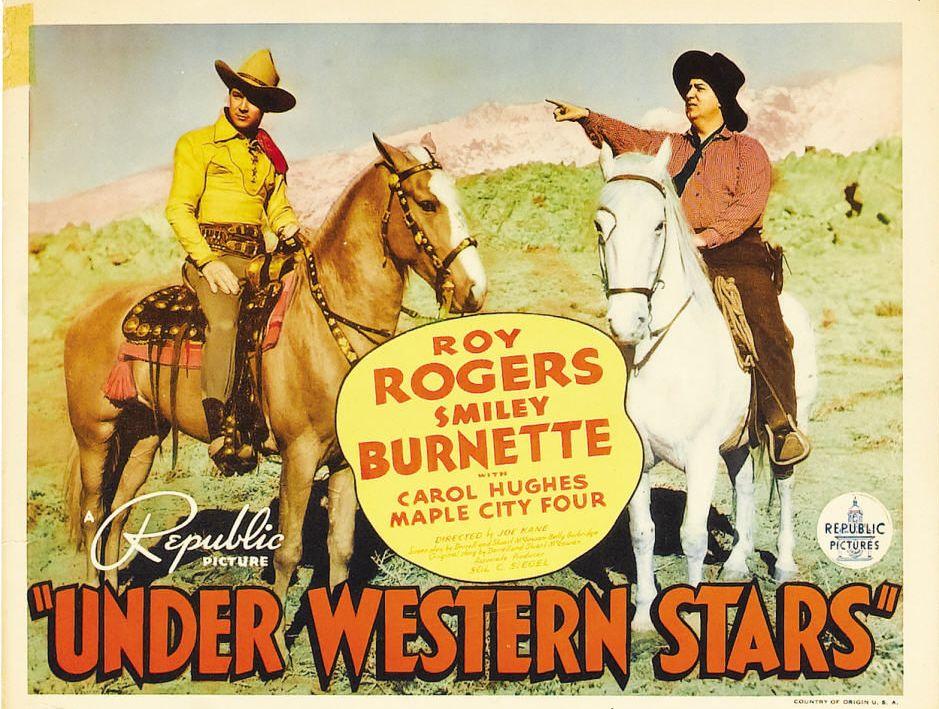 Lobby card with Roy Rogers (L) on his golden palomino stallion, Trigger, and Smiley Burnette in the 1938 film "Under Western Stars." (Republic Pictures)
