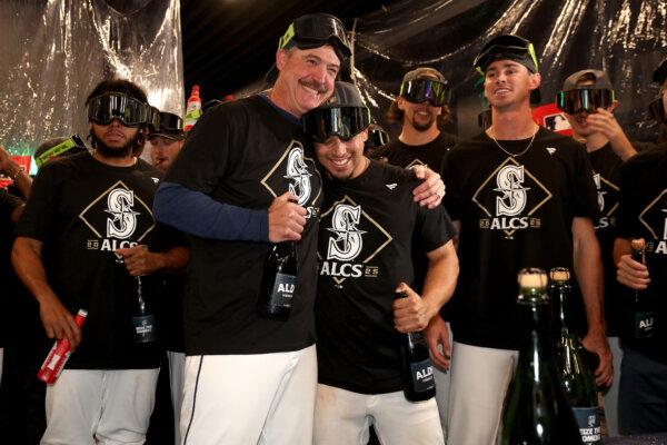 Manager Dan Wilson and infielder Leo Rivas celebrate in the locker room after the Mariners defeated the Detroit Tigers in Game 5 of the American League Division Series at T-Mobile Park in Seattle on Oct. 10, 2025. (Steph Chambers/Getty Images)
