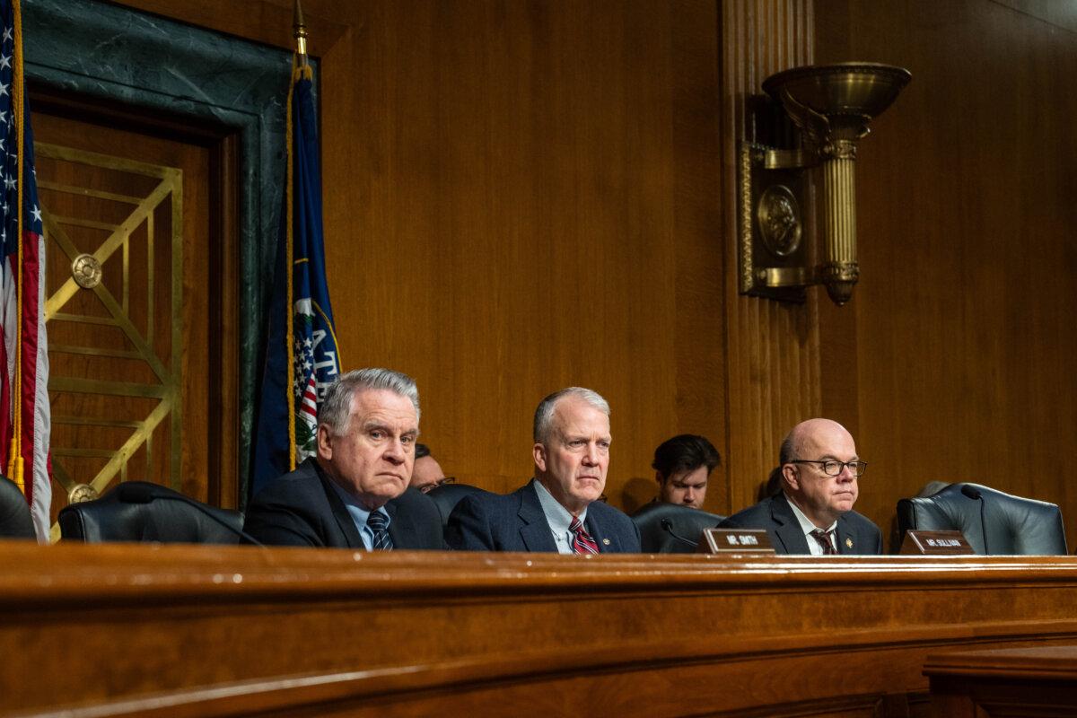 Co-chair of the Congressional-Executive Commission on China (CECC) Rep. Chris Smith (R-N.J.), Chairman Sen. Dan Sullivan (R-Alaska), and Rep. James McGovern (D-Mass.), listen to testimonies during a hearing on Capitol Hill in Washington on Nov. 20, 2025. (Madalina Kilroy/The Epoch Times)
