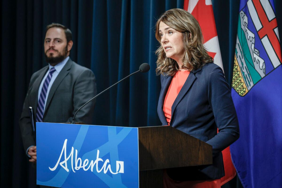 Alberta Premier Danielle Smith and Education Minister Demetrios Nicolaides at a press conference in Calgary on Oct. 17, 2025. (Jeff McIntosh/The Canadian Press)