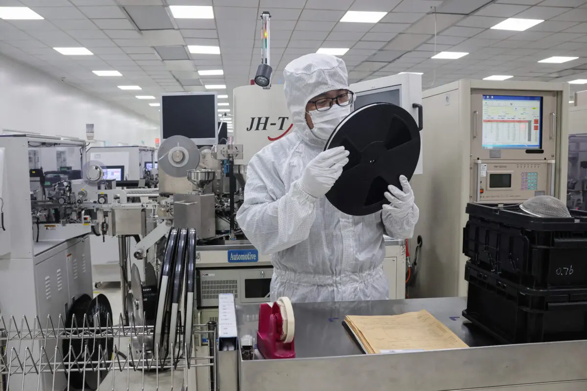 An employee inspect semiconductor chips at a factory in Binzhou, in eastern China's Shandong Province, on Jan. 15, 2025. (STR/AFP via Getty Images)