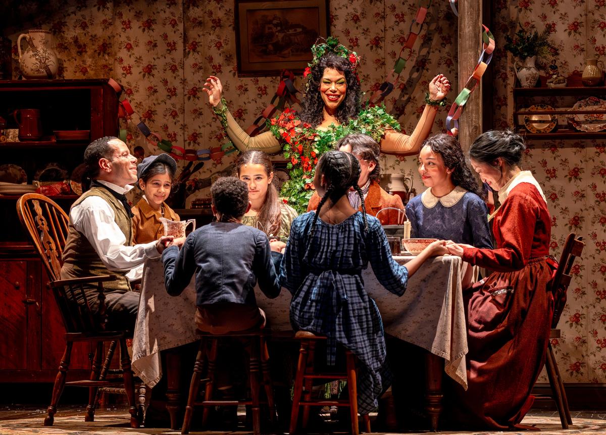 The Cratchit family gathers for a meal, in "A Christmas Carol." (Brett Beiner)