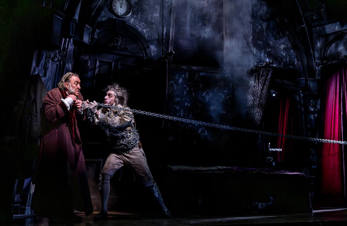 Ebenezer Scrooge (Christopher Donahue, L) learns his lesson when his former business partner Marley (Daniel Jose Molina) shows up, in "A Christmas Carol." (Brett Beiner)