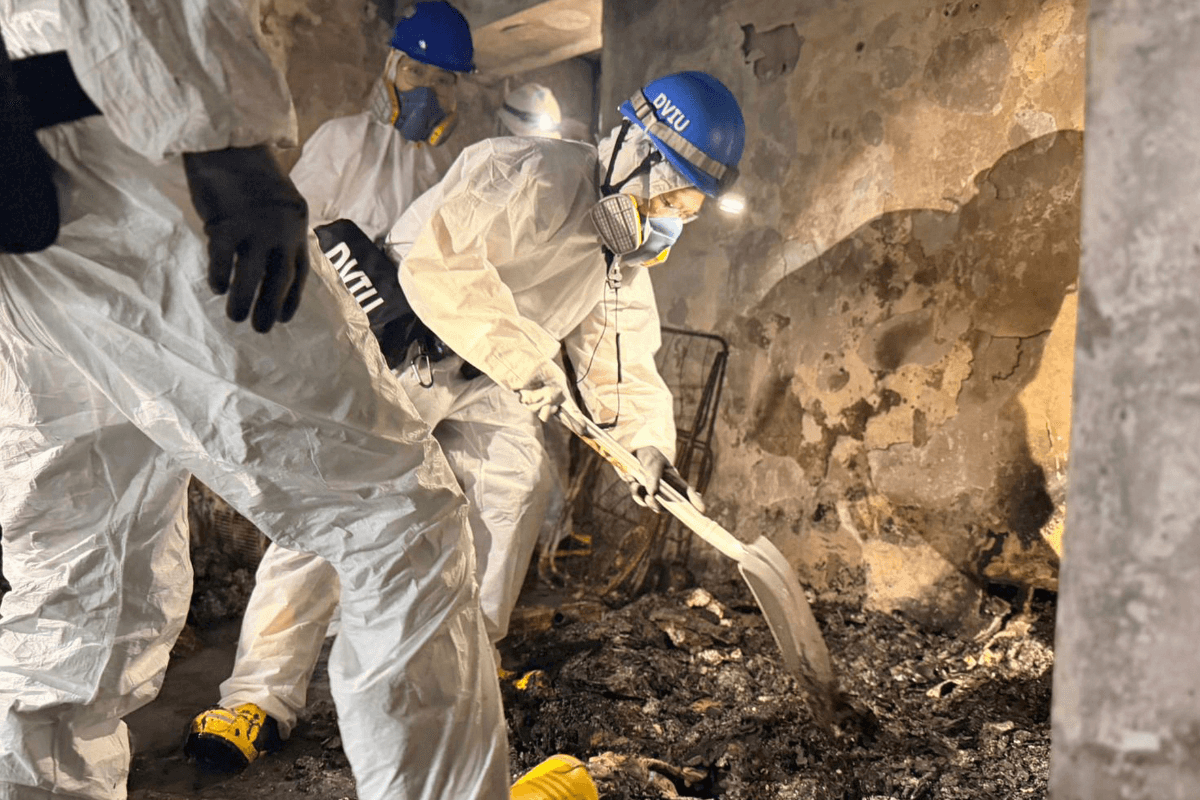 Members of the Disaster Victim Identification Unit work in an apartment in the aftermath of a deadly Wednesday fire at Wang Fuk Court, a residential estate in the Tai Po district, New Territories, Hong Kong, on Nov. 30, 2025. (Hong Kong Police Public Relations Branch via AP)