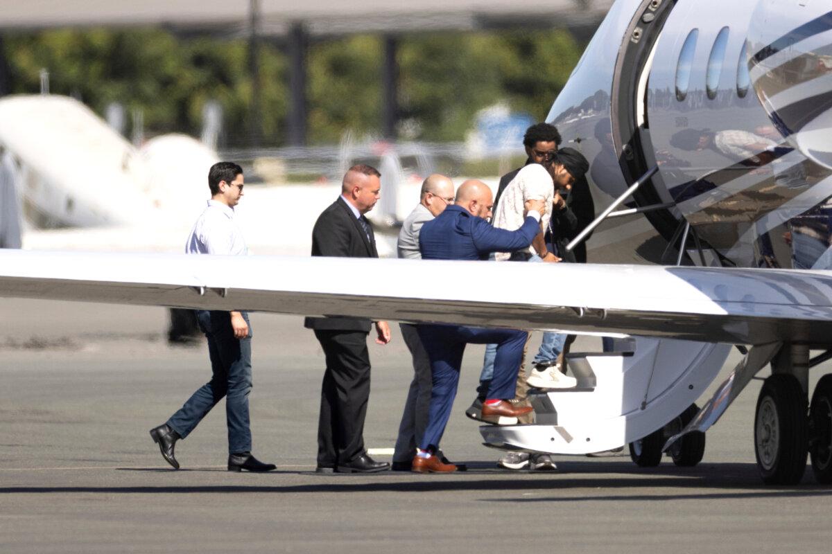 Harjinder Singh is escorted onto an airplane by Florida Lt. Gov. Jay Collins and law enforcement in Stockton, Calif., on Aug. 21, 2025. (Benjamin Fanjoy/AP Photo)