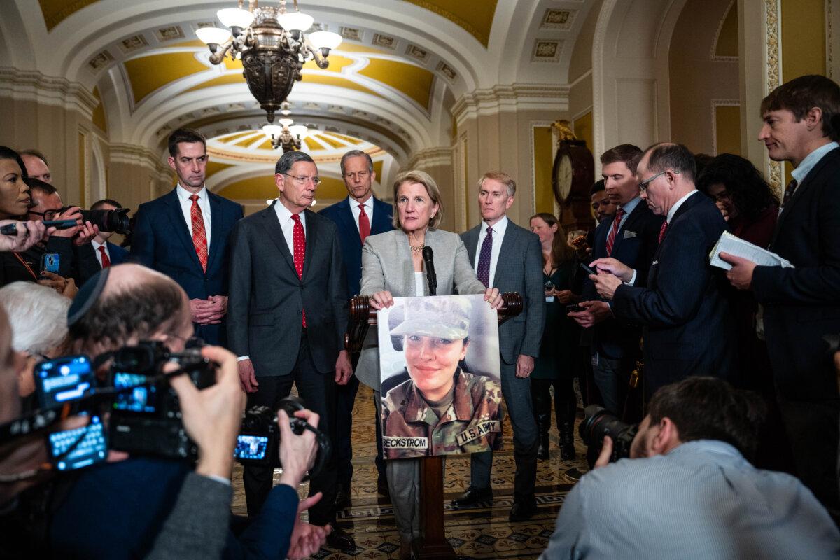 Sen. Shelley Moore Capito (R-W.Va.) holds a photo of Army Spc. Sarah Beckstrom, a West Virginia National Guard member who was shot near the White House on Nov. 26, in Washington on Dec. 2, 2025. (Madalina Kilroy/The Epoch Times)
