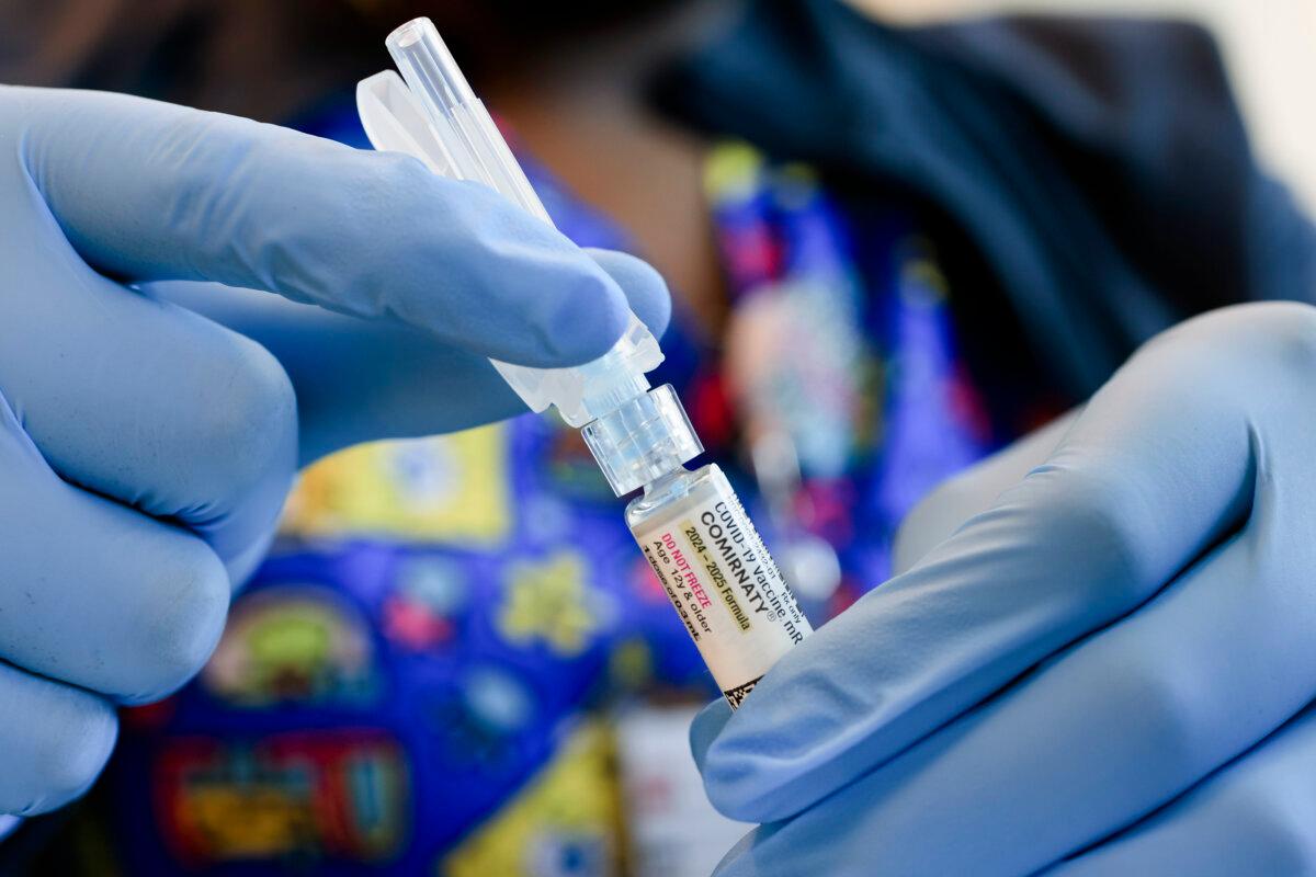 An immunization nurse holds a Pfizer-BioNTech COVID-19 vaccine at Borinquen Health Care Center in Miami on May 29, 2025. (Joe Raedle/Getty Images)