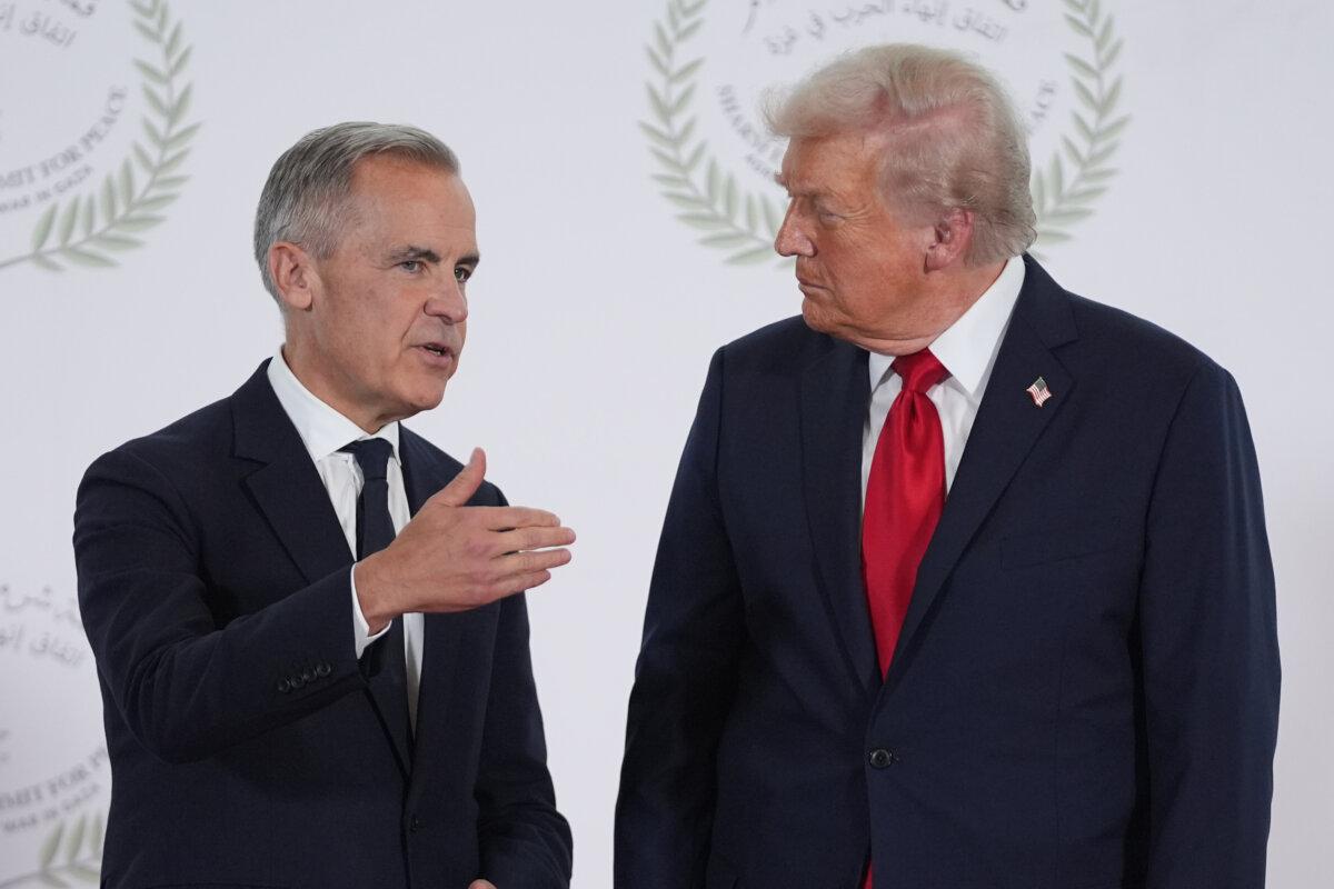 U.S. President Donald Trump greets Canadian Prime Minister Mark Carney during a summit on ending the Israel-Hamas war, in Sharm El Sheikh, Egypt, on Oct. 13, 2025. (AP Photo/Evan Vucci, Pool)