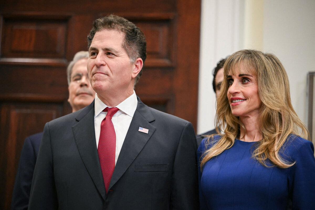 Michael Dell, CEO of Dell Technologies, and his wife Susan look on during an announcement of a $6.25 billion donation from the Dell family to Trump Accounts in the White House on Dec. 2, 2025. (Andrew Caballero-Reynolds/AFP via Getty Images)