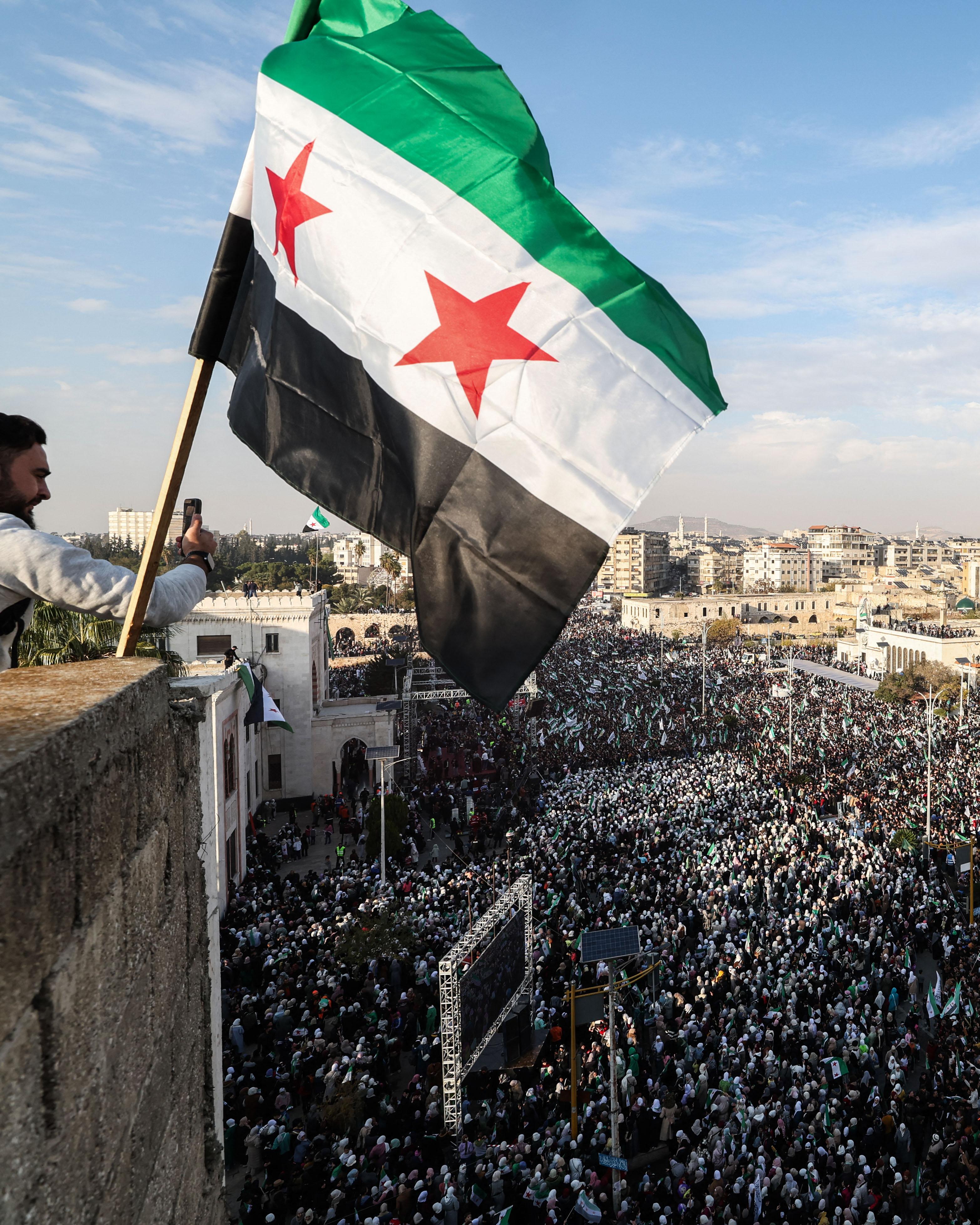 Day in Photos: Celebrations in Syria, World Cup Official Draw, Refugees in Rwanda