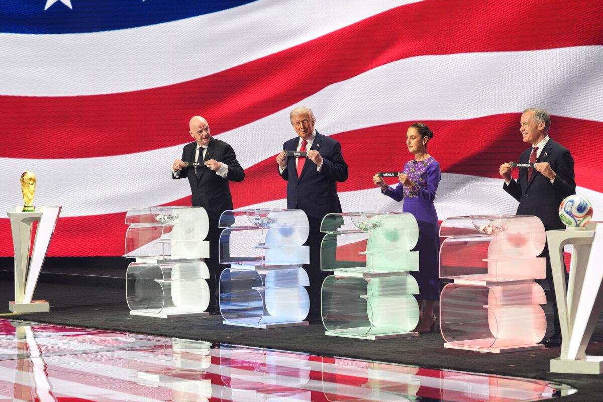 (R–L) Canadian Prime Minister Mark Carney, Mexican President Claudia Sheinbaum, President Donald Trump and FIFA President Gianni Infantino hold up country names during the draw for the 2026 soccer World Cup at the Kennedy Center in Washington on Dec. 5, 2025. (Jacquelyn Martin/AP Photo)