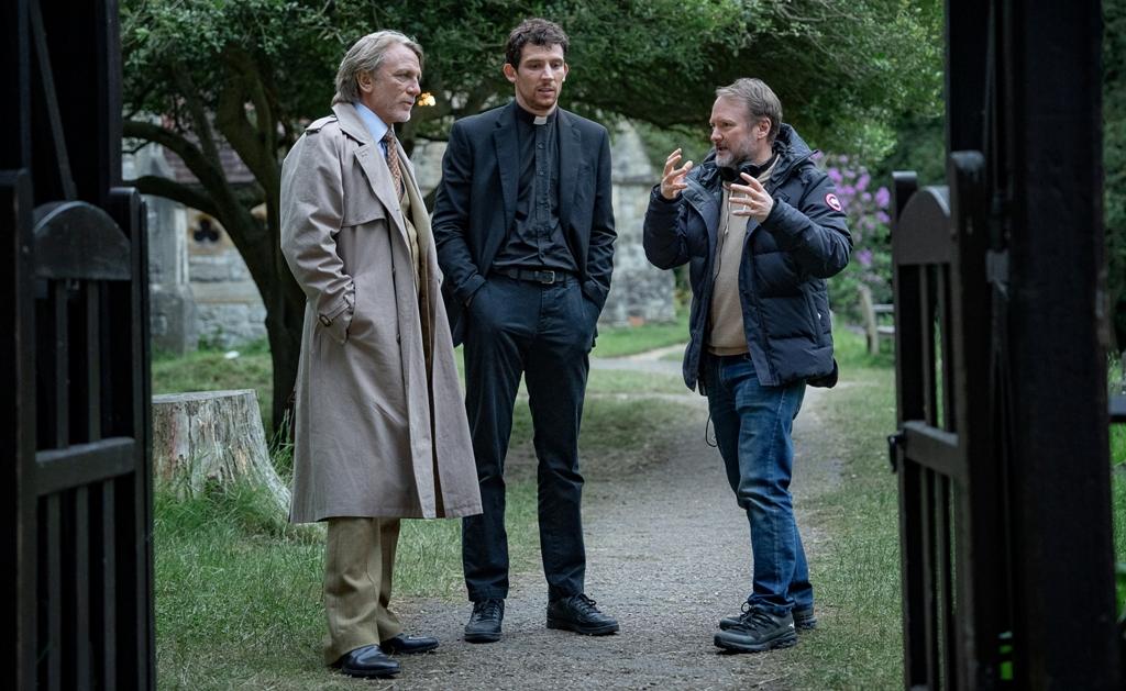 (L-R) Daniel Craig, Josh O’Connor, and writer-director Rian Johnson on the set of "Wake Up Dead Man: A Knives Out Mystery." (John Wilson/Netflix)
