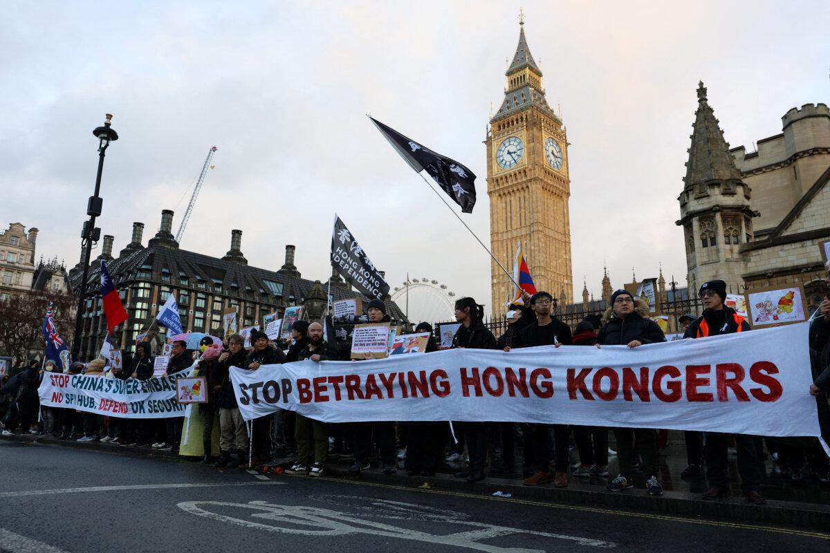 Protesters gather with placards in London on Dec. 6, 2025, to demonstrate against a proposal to move China’s embassy to a new site a stone's throw from the Tower of London and call for the UK government ‘to acknowledge its responsibility in the Far East.’ China has for several years been trying to relocate its embassy to a sprawling historic site in the shadow of the Tower of London. (Toby Shepheard/AFP via Getty Images)